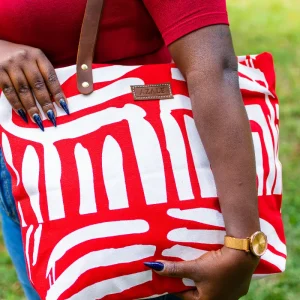 Red Azale Alice Tote Bag hanging from shoulder