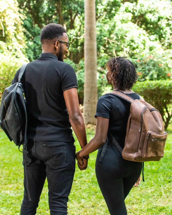 Couple carrying brown and black Azale leather backpack