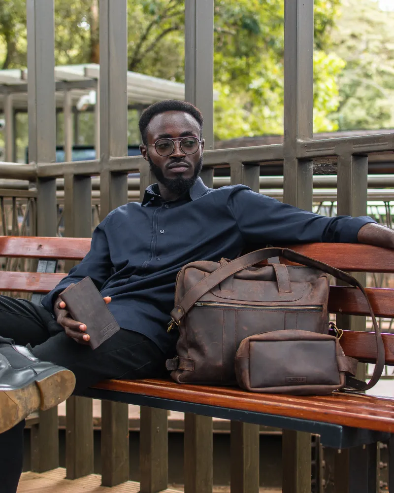 Coffee brown Steha messenger bag in park backdrop